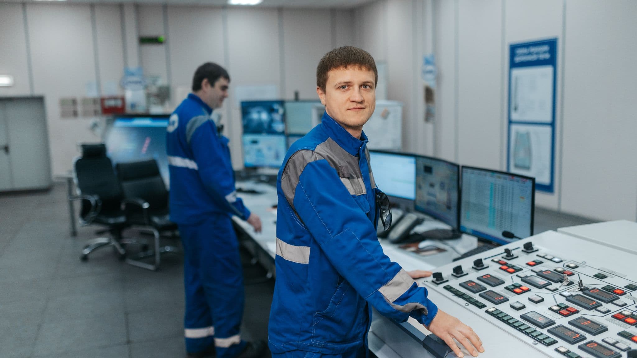 Two technicians at an equipment control panel in an industrial control room, anthropic usage policy update, Aceleron Intelligence